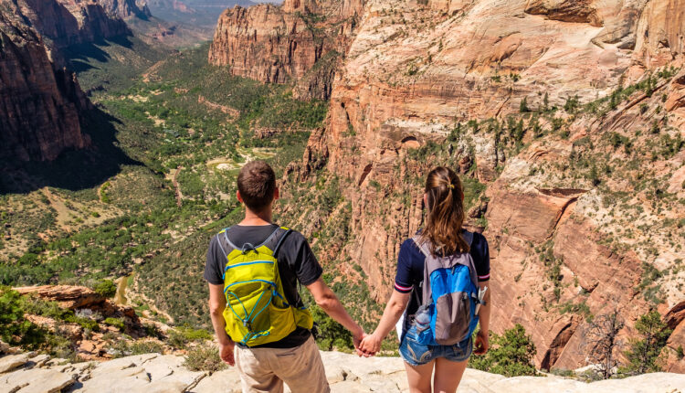 Tourists with backpack hiking in Zion